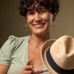 smiley-woman-holding-hat-medium-shot